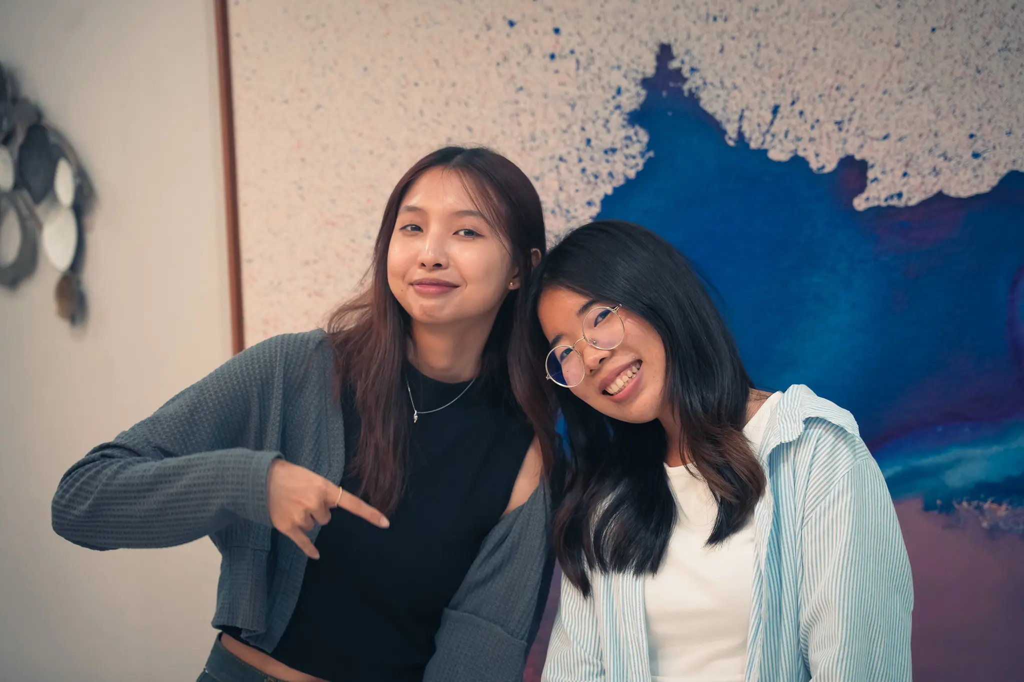 Two Issa Compass teammates posing together in the office