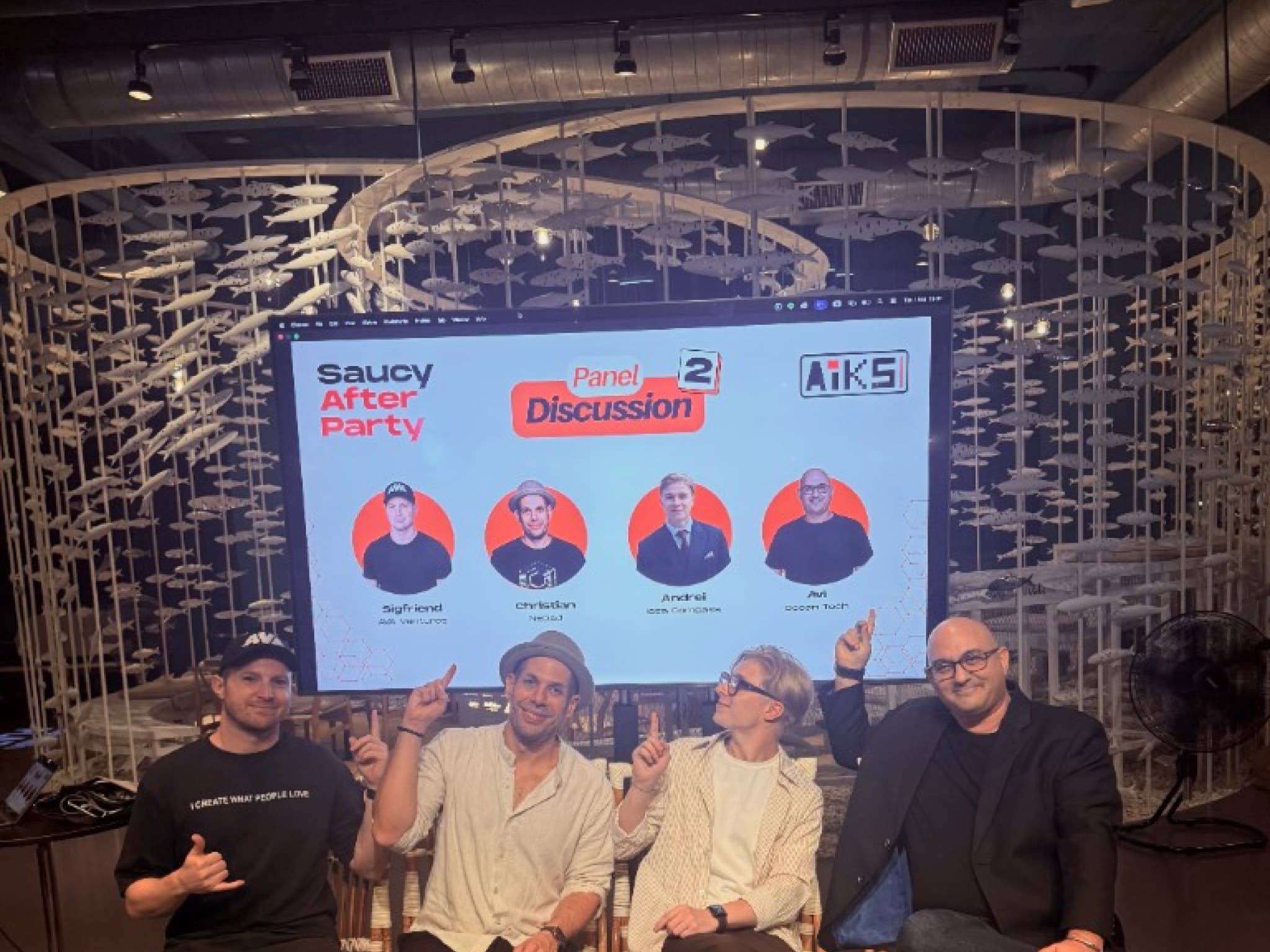 Panelists seated in front of the Saucy After Party screen at Glowfish Plaza Sathorn, with the AIKS fish installation behind them