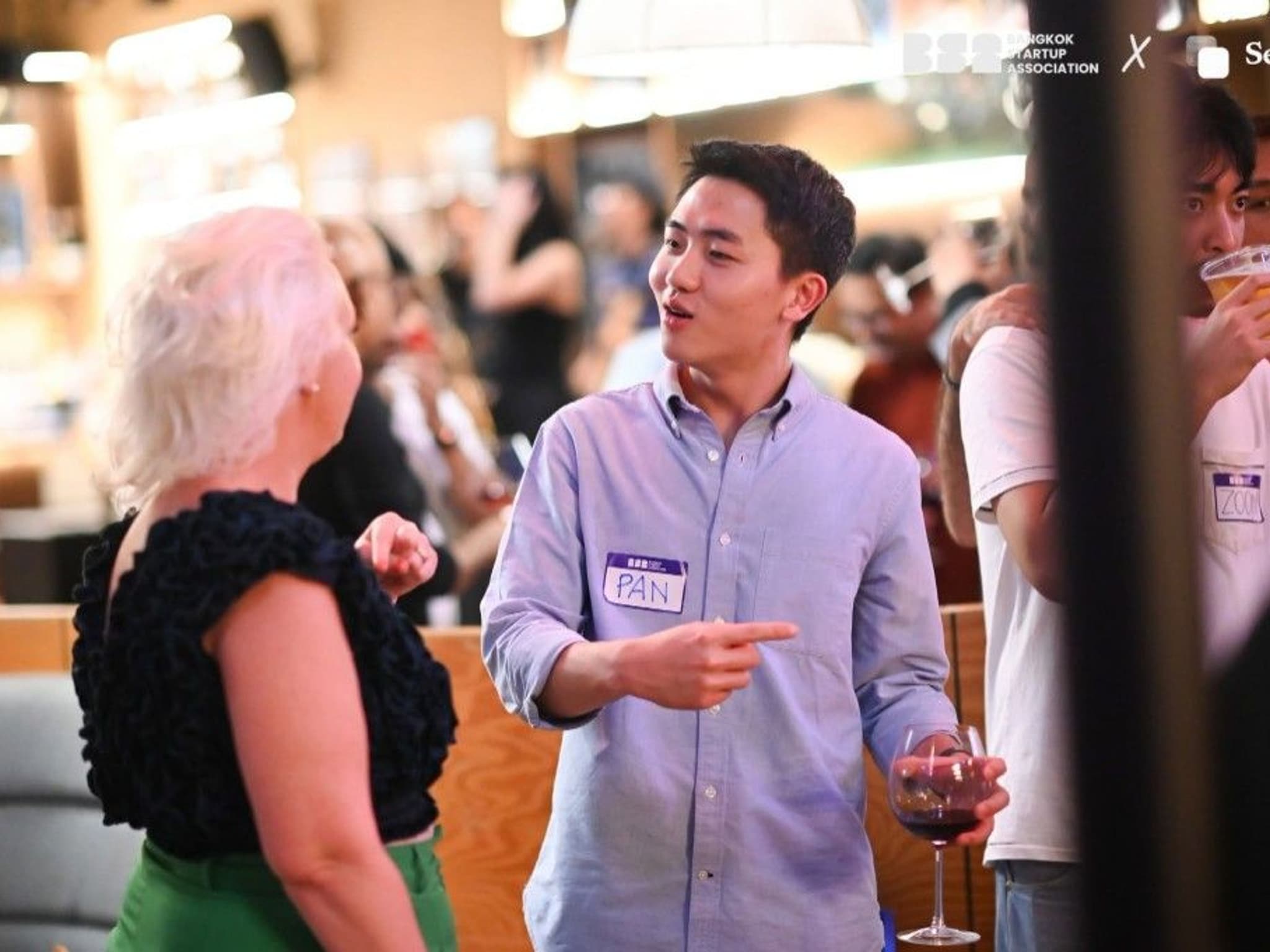Pan Karnjanaekarin of Issa Compass in conversation over a glass of red wine at the Bangkok Startup Association NØTWORKING Night at Vinyl & Wine, Emsphere
