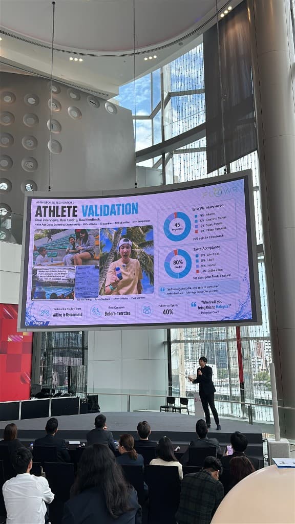 A founder pitching athlete validation research on the Chula Demo Day stage at SCBX NEXT TECH