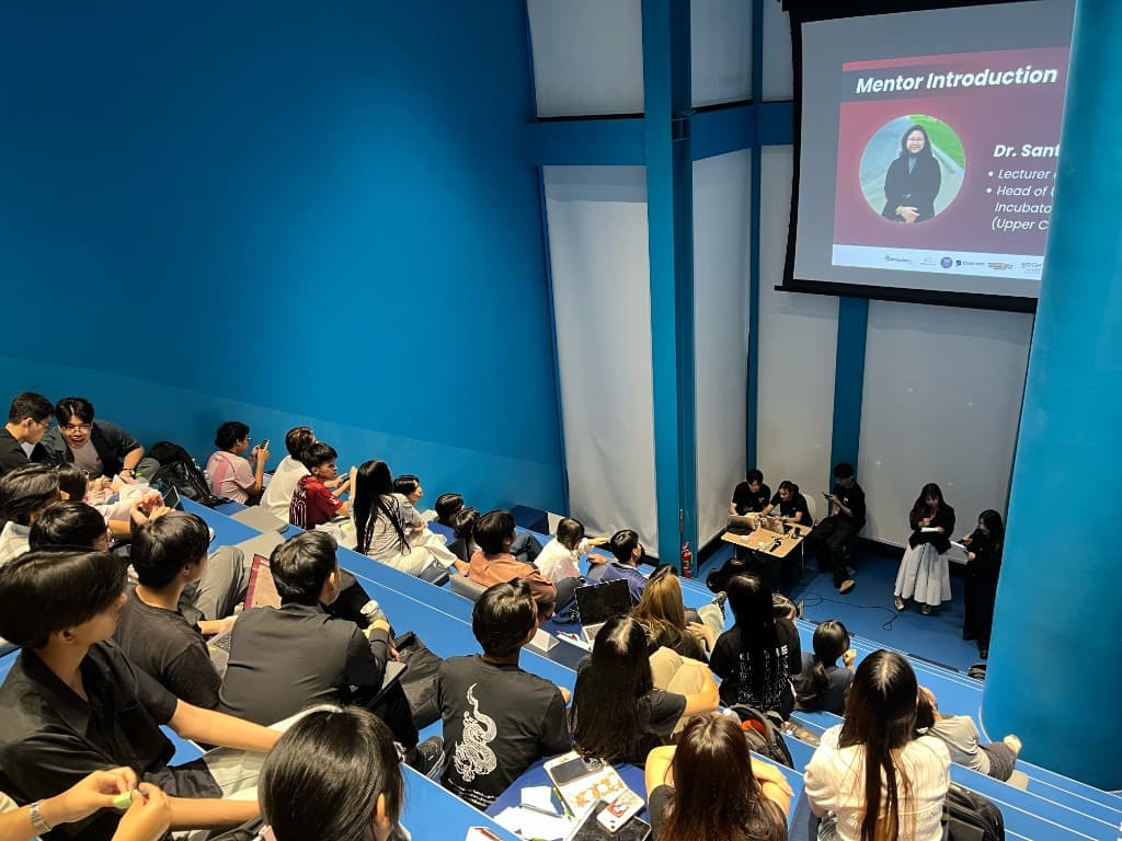 Students in a lecture hall during a UniHack 2026 mentoring session