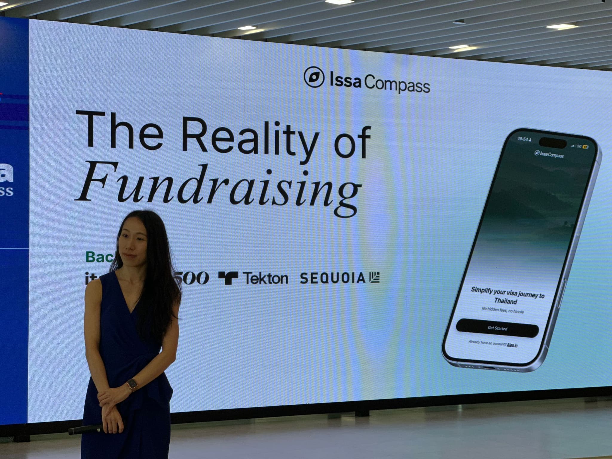 Priscilla Yeung speaking on stage at Generali Thailand Town Hall with The Reality of Fundraising on screen behind her