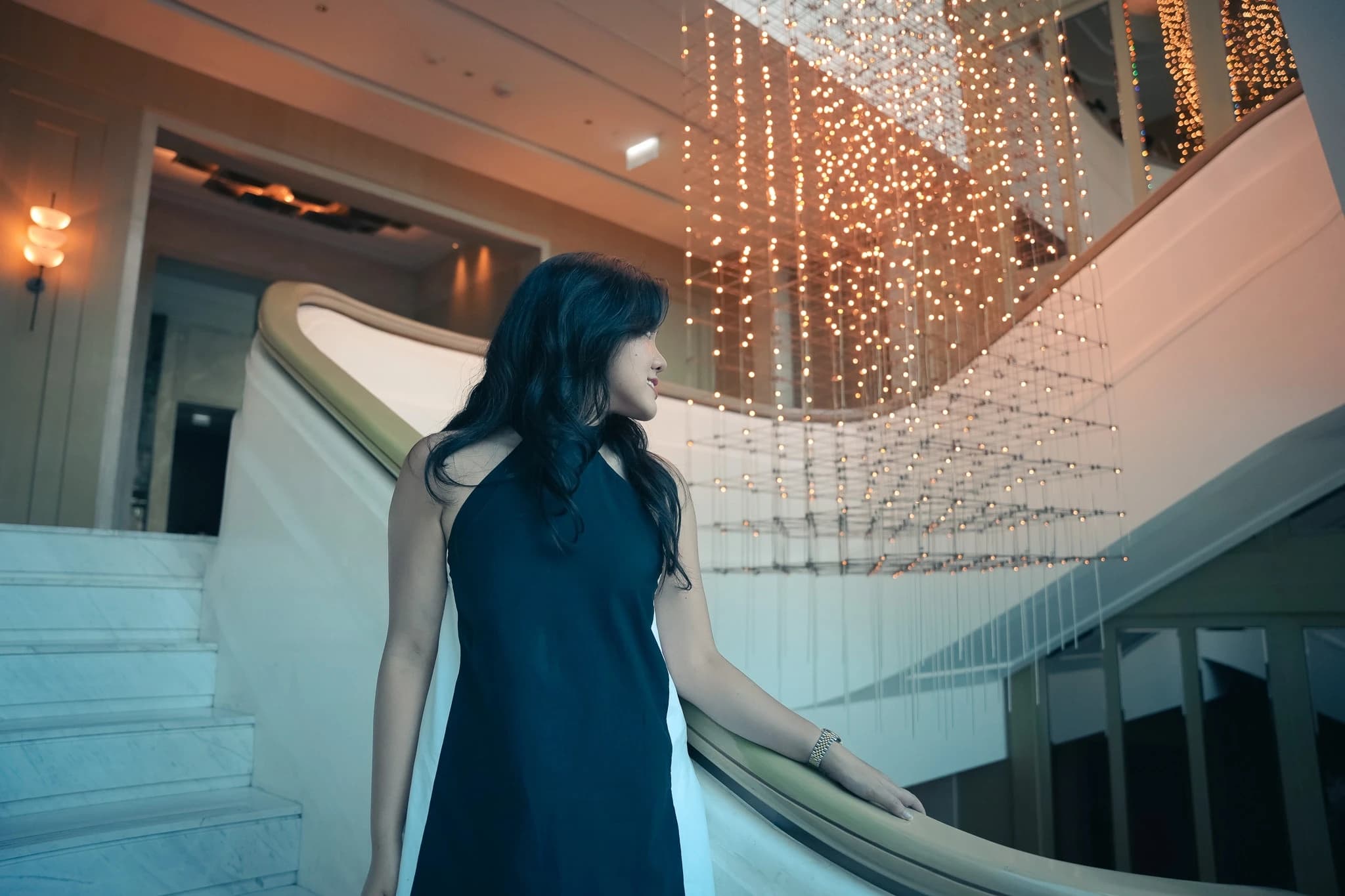 Guest on a marble staircase in a luxury lobby
